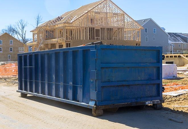 dumpsters lined up at a residential development site